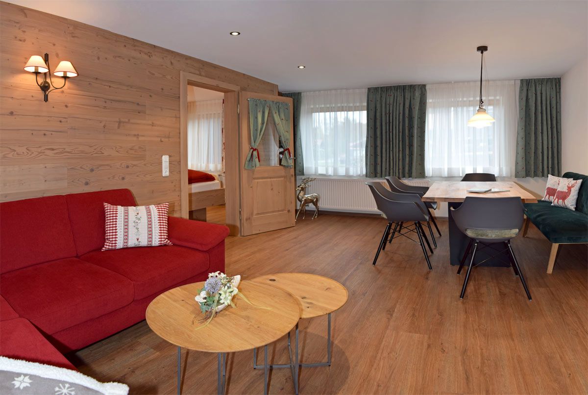 Großer Wohnraum mit Sofam Essbereich und Fernseher im Landhaus Stil